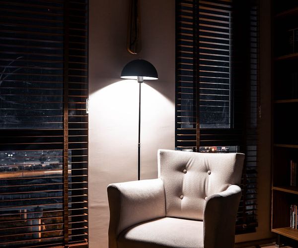 Cozy room with a comfortable chair and soft, warm lighting.