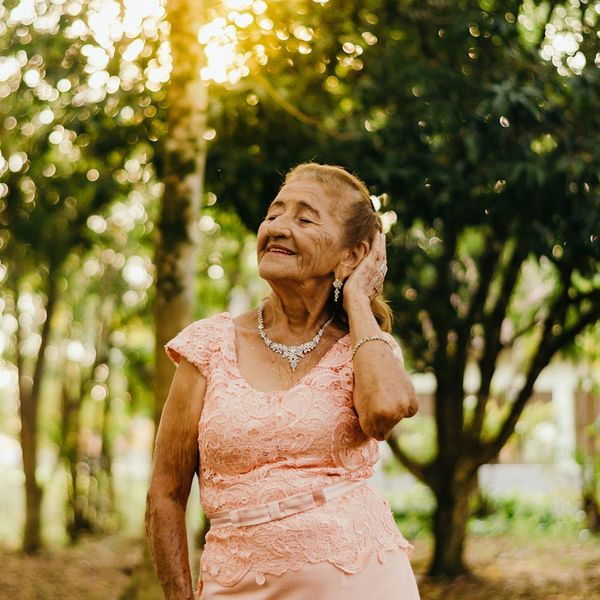 Woman with closed eyes peacefully smiling, embodying tranquility.
